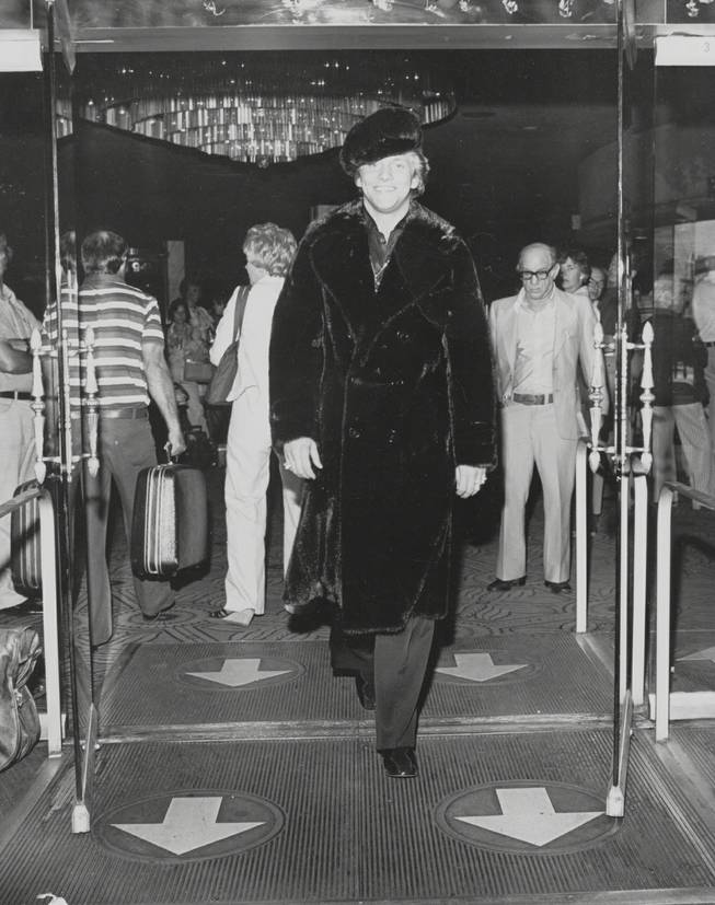 Scott Thorson leaves the Dunes Hotel, still wearing the black llama .jacket and cap he modeled there for Anna Nateece's fashion show.  Scott was Liberace's lover (played recently by Matt Damon in 'Behind the Candelabra)  and Anna was Liberace's gown and fur designer.  Circa 1980.  Courtesy Anna Nateece's.